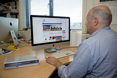 Man at desk looking at RNLI jobs website